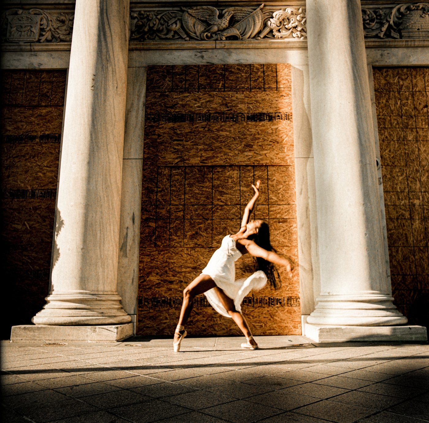 A dancer captured mid-movement in a public space.