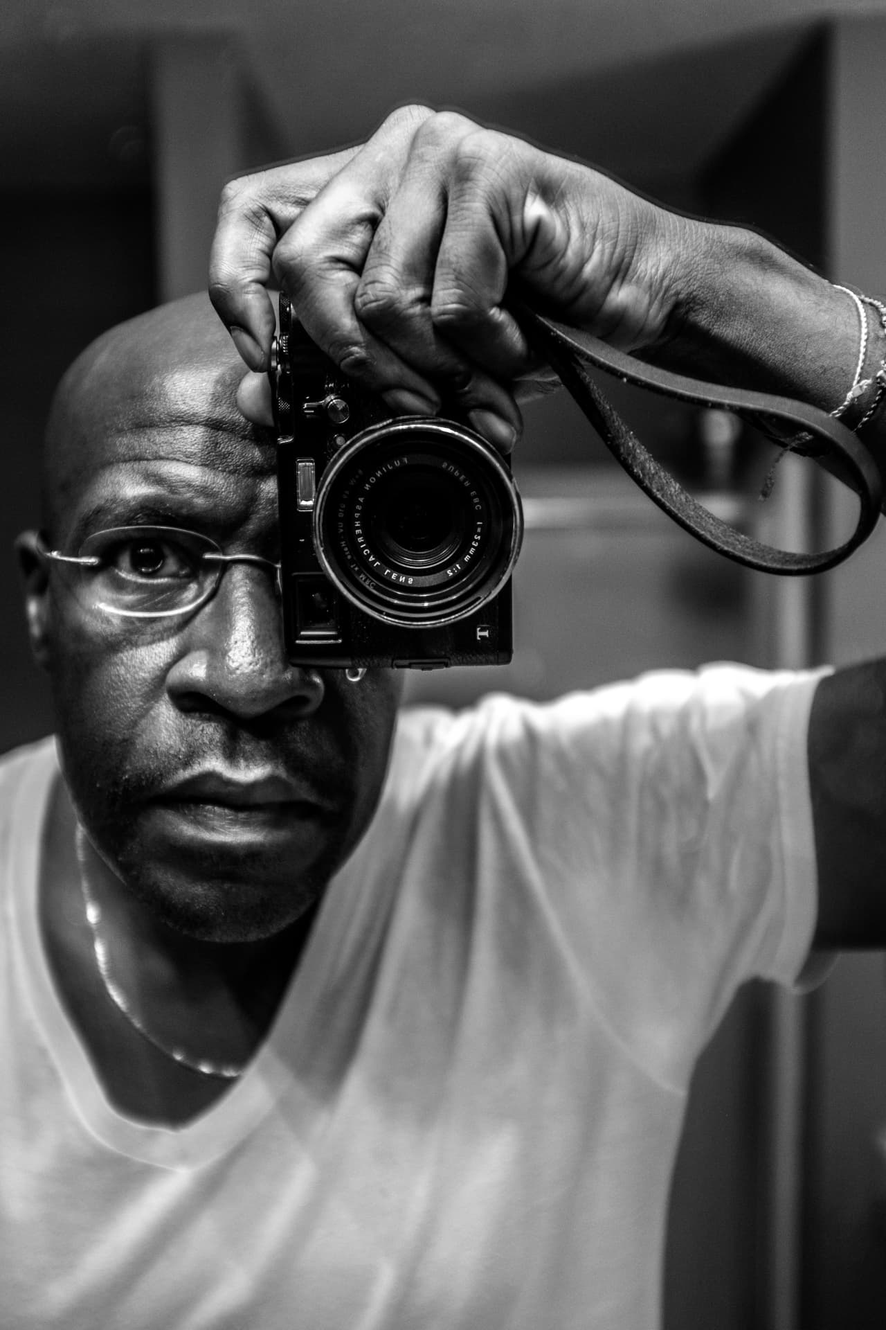 Ken West holding a rangefinder camera to his eye